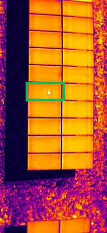 Solar panel with a bright hotspot indicating overheating in one section, highlighting potential efficiency loss and damage risk.