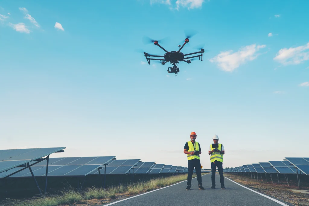Drone inspecting solar panels using aerial imaging to detect faults and performance issues.