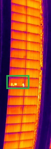 Thermal image of a solar panel showing multiple hotspots caused by electrical faults or damaged cells.