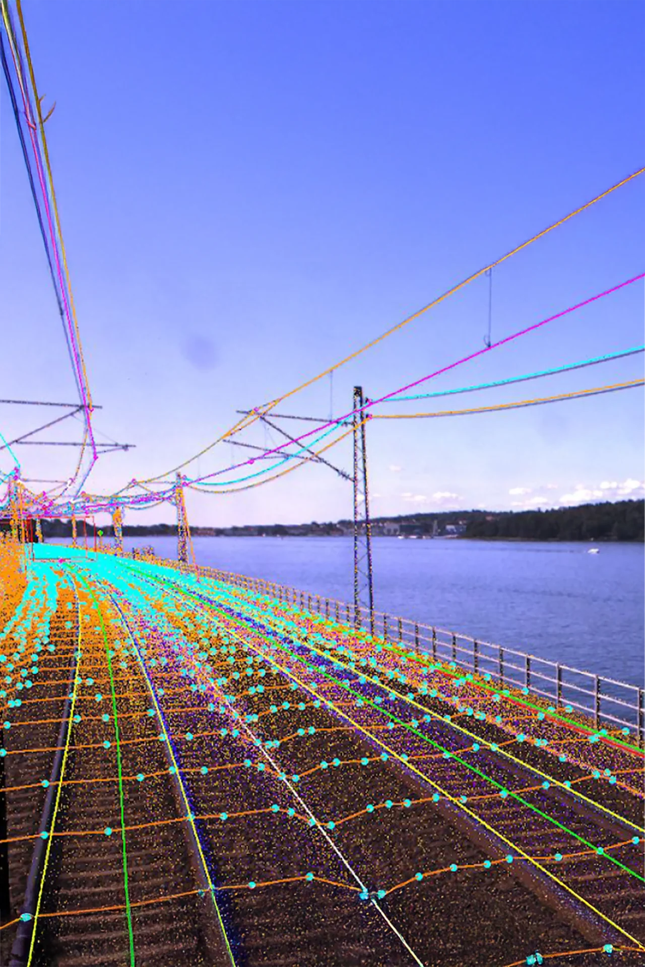 Drone equipped with LiDAR scanning railway tracks for 3D mapping and survey purposes.