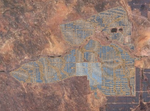Aerial orthomosaic of a building rooftop with multiple solar panels arranged in rows, showing detailed panel alignment and rooftop features