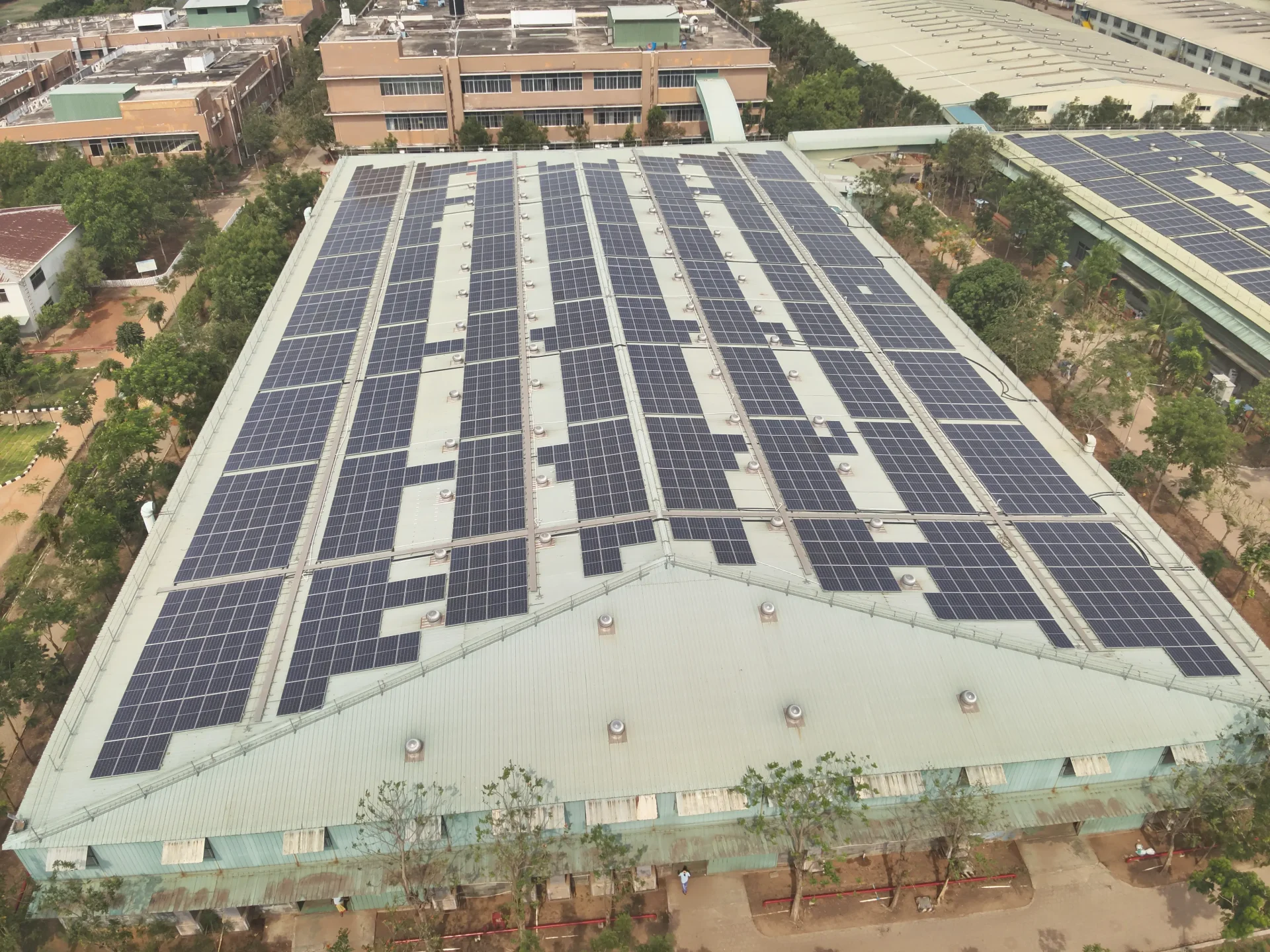 A Drone checking a building roof for sunlight and space to install solar panels.