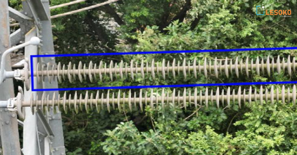 Transmission line tower inspection showing high voltage insulators fixed on steel structure