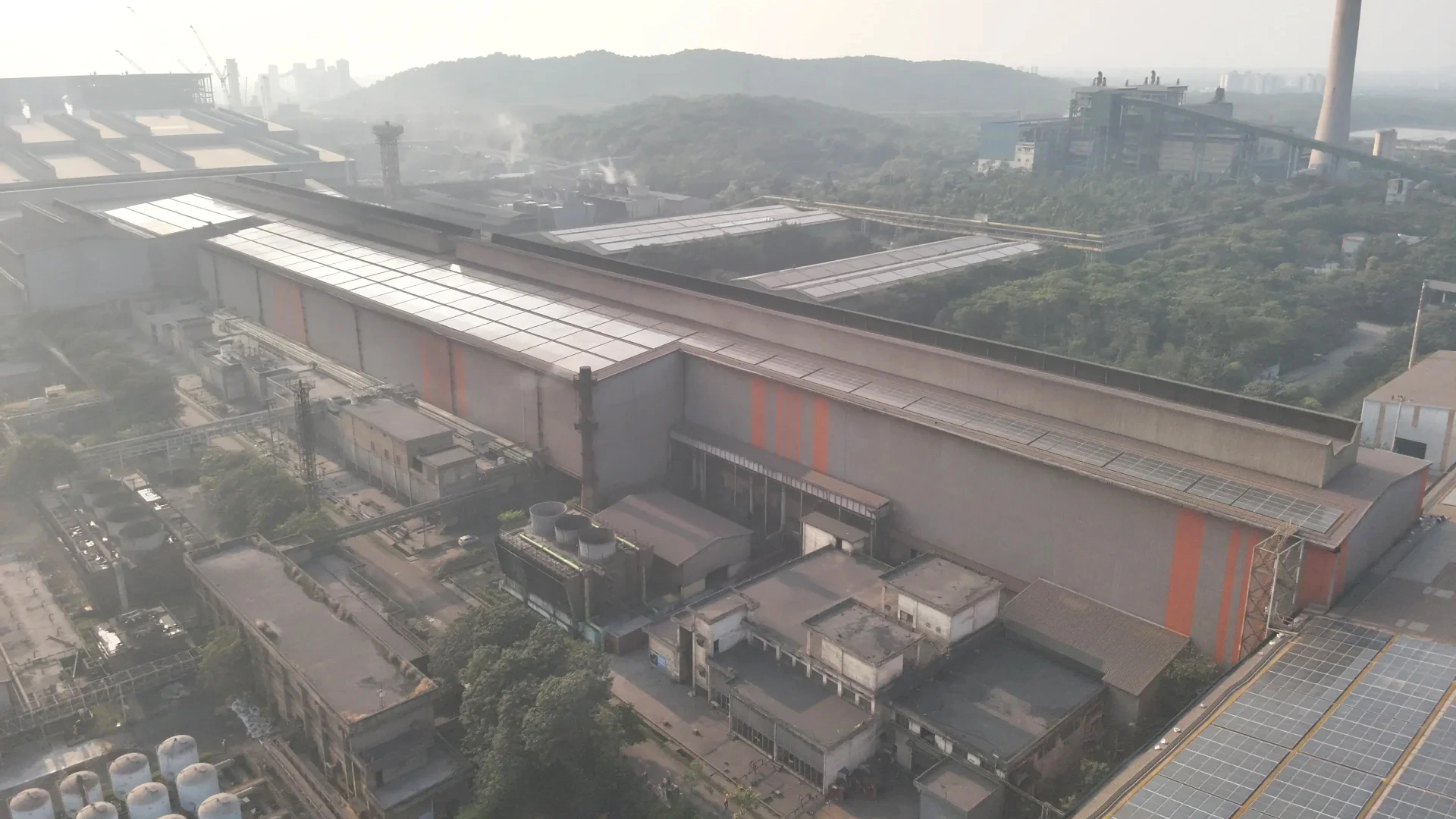 Drone capturing roof data for solar rooftop survey and solar panel installation planning on a commercial building in India