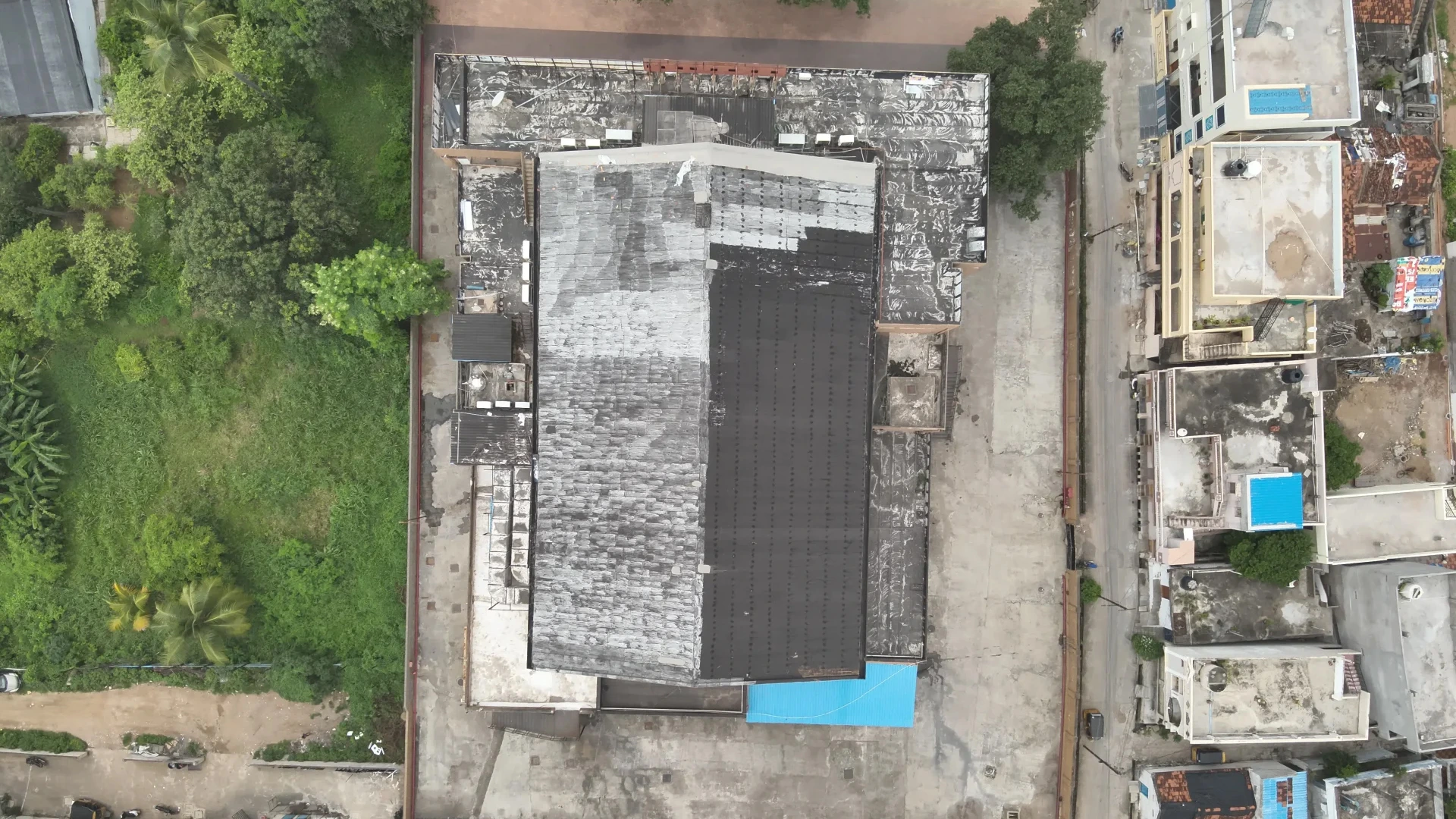 Drone capturing roof data for solar rooftop survey and solar panel installation planning on a commercial building in India