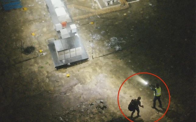 Drone night surveillance image showing security guard alertness audit at solar farm construction site during night patrol