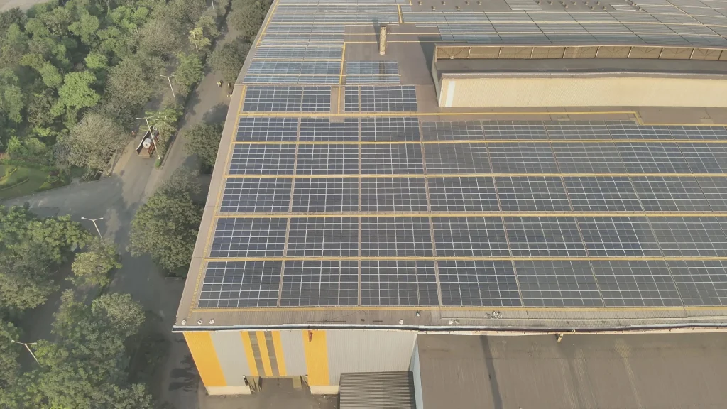 Drone inspecting solar panels on a rooftop for accurate solar rooftop survey and structural safety assessment in India