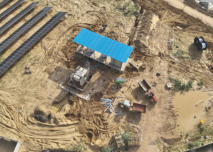 Drone solar project progress monitoring capturing cable laying and inverter room construction at solar farm India