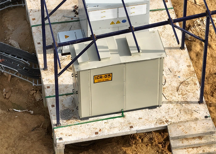 Close-up drone image of an installed ICR inverter panel on a concrete plinth within a solar construction site — the level of equipment-level detail only aerial monitoring can capture systematically across large sites.