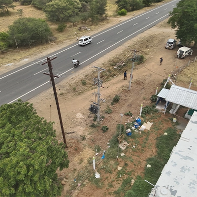 Drone survey of a highway corridor showing utility pole clearance assessment for WTG component transport route planning in India