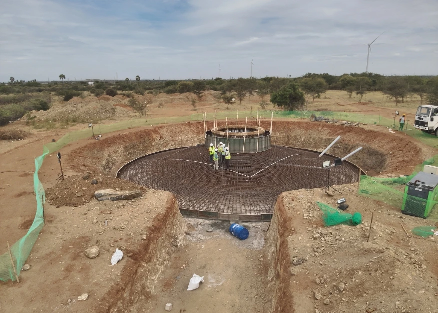 Drone view of wind turbine foundation excavation and reinforcement steel work during construction phase at wind farm project in India