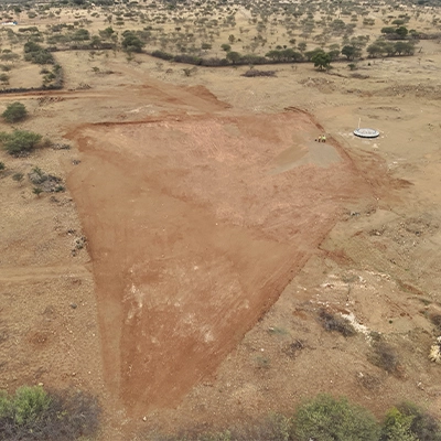 Drone aerial view of a cleared wind turbine foundation pad during pre-construction site survey in India