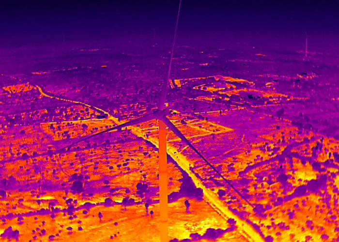 Top-down thermal infrared drone image of wind turbine showing all three blades during UAV inspection for delamination and heat anomaly detection in India