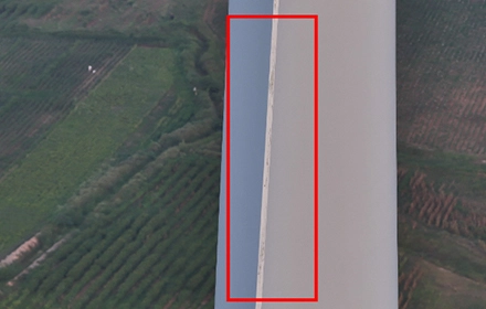 Aerial UAV image of wind turbine blade surface showing seepage and moisture discolouration, marked with red rectangle during drone inspection in India