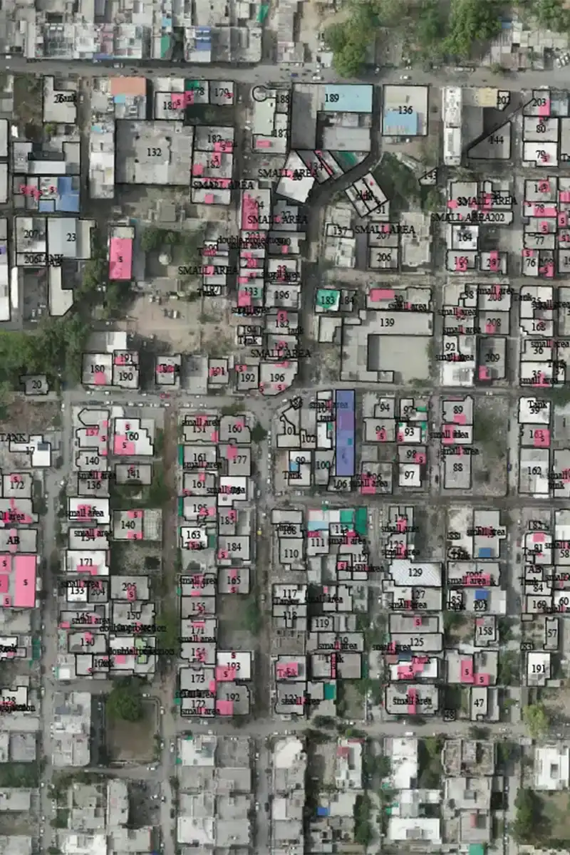 Annotated aerial rooftop survey map showing numbered buildings with colour-coded classifications for solar potential assessment