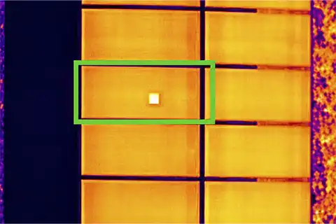 Radiometric thermal image of solar panel with single cell-level hotspot highlighted by green bounding box
