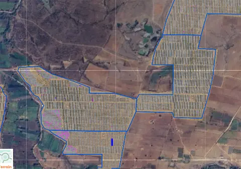 Geo-referenced orthomosaic of ground-mount solar farm with blue boundary outline and panel array sections visible