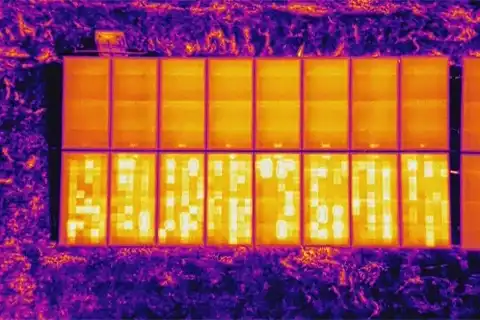 Aerial thermal image showing string reverse polarity fault with bright cell clusters across lower panel row