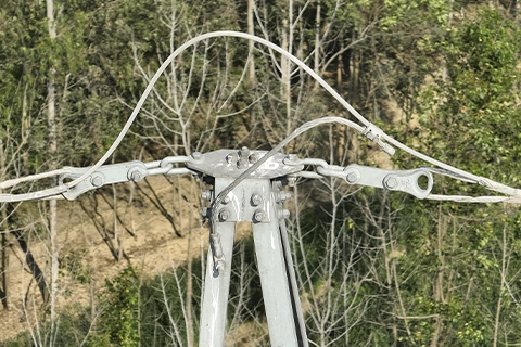 Ground wire connection loop at the peak cross-arm of a transmission tower