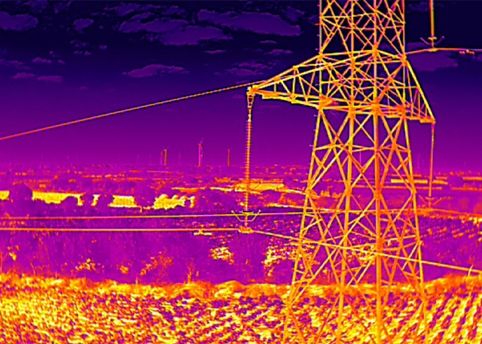 Radiometric thermal image of transmission tower and corridor showing temperature variation across landscape